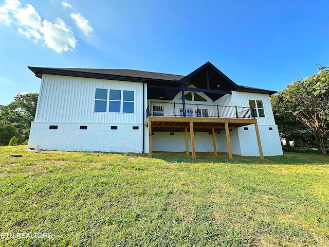 rear view of house with crawl space, a yard, and a wooden deck