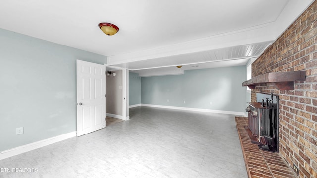 unfurnished living room with brick wall and a brick fireplace