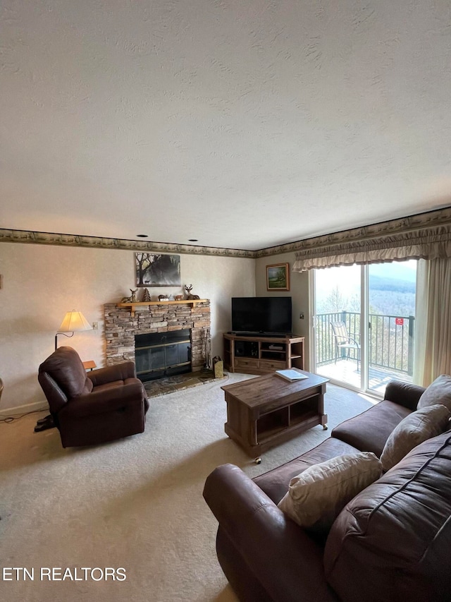 living room with a fireplace, a textured ceiling, and carpet floors