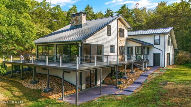 back of house with a yard and a deck