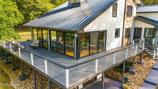 back of house with a wooden deck