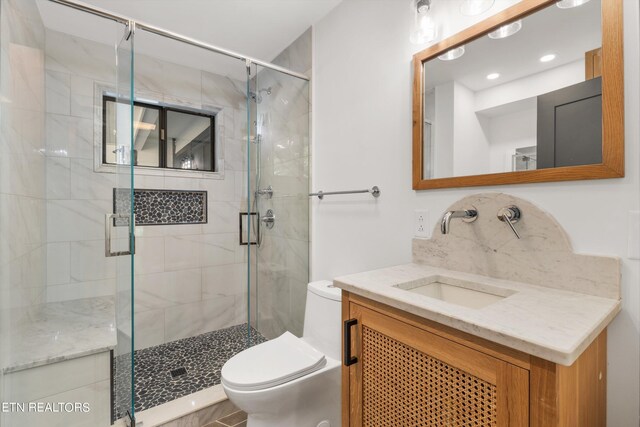 bathroom featuring vanity, toilet, and walk in shower