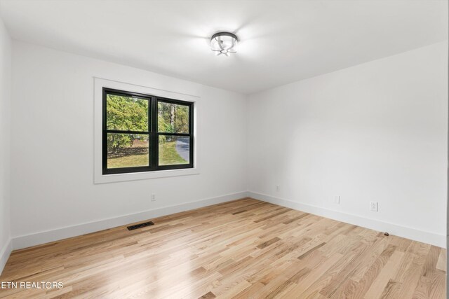 unfurnished room with light hardwood / wood-style floors