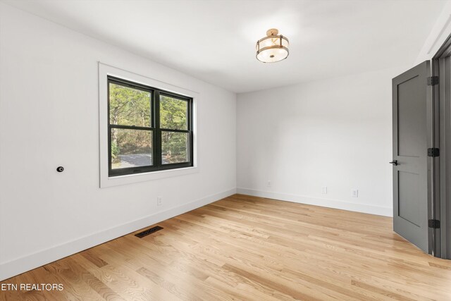 empty room with light hardwood / wood-style floors