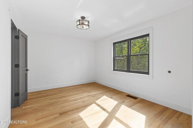 empty room with light hardwood / wood-style floors