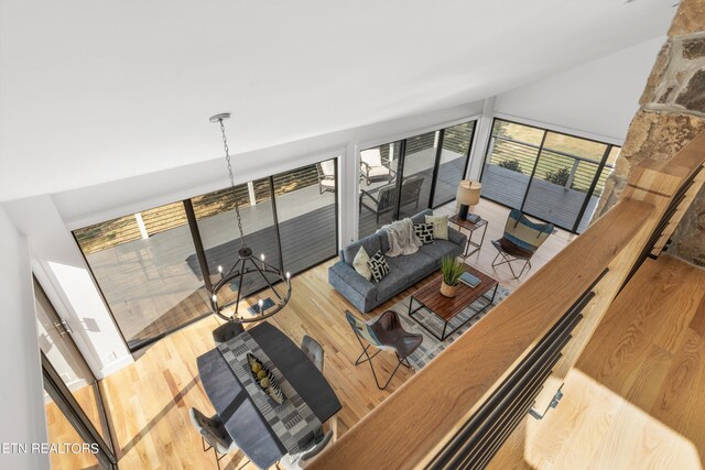 living room featuring hardwood / wood-style flooring and an inviting chandelier