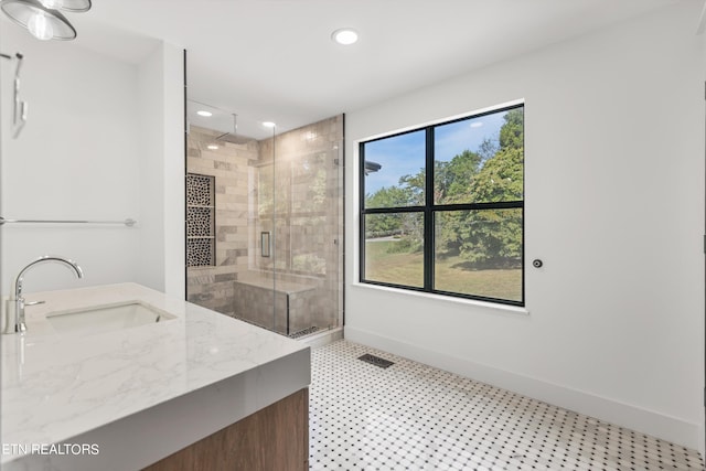 bathroom featuring vanity and an enclosed shower