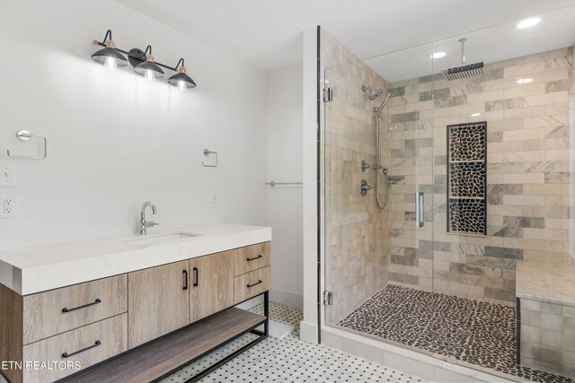 bathroom featuring vanity and an enclosed shower