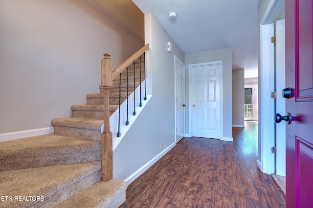 entryway with dark hardwood / wood-style floors