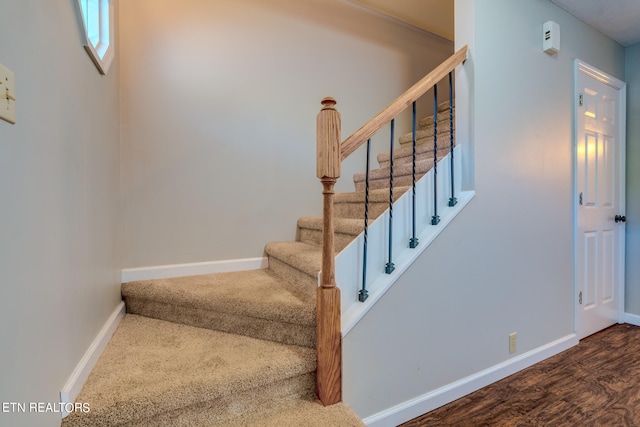 stairs featuring hardwood / wood-style floors