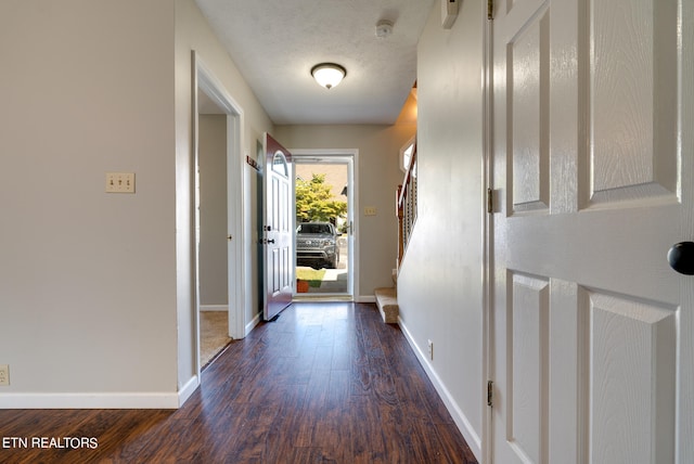 interior space with dark wood-type flooring and a textured ceiling