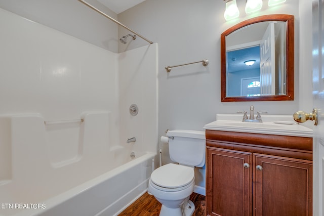 full bathroom featuring washtub / shower combination, wood-type flooring, toilet, and vanity