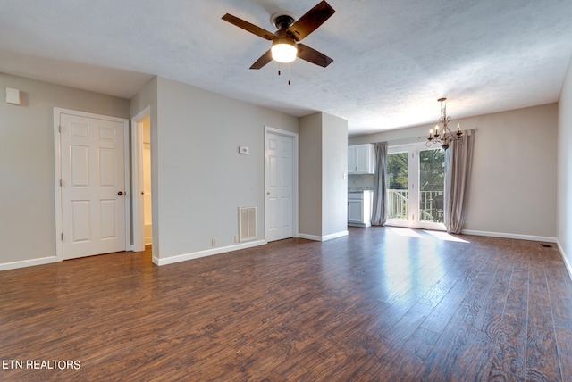 unfurnished room featuring dark wood-type flooring, ceiling fan with notable chandelier, and a textured ceiling