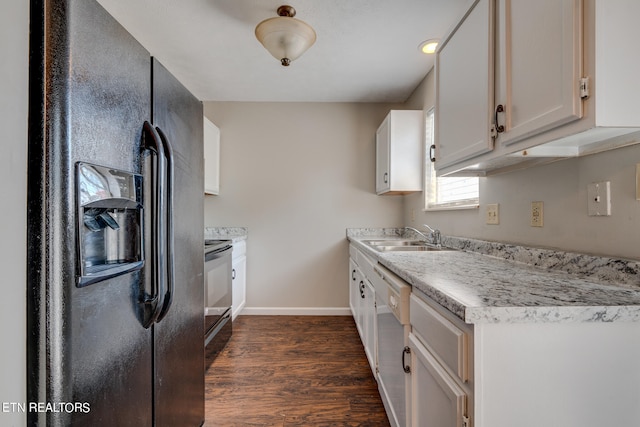 kitchen featuring black refrigerator with ice dispenser, white dishwasher, sink, dark hardwood / wood-style floors, and white cabinets