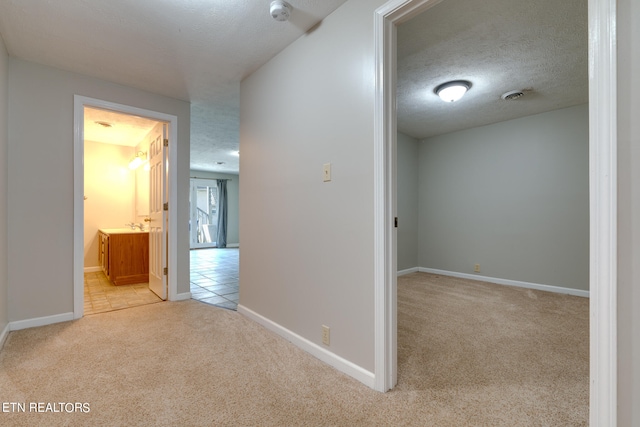 interior space featuring sink and a textured ceiling