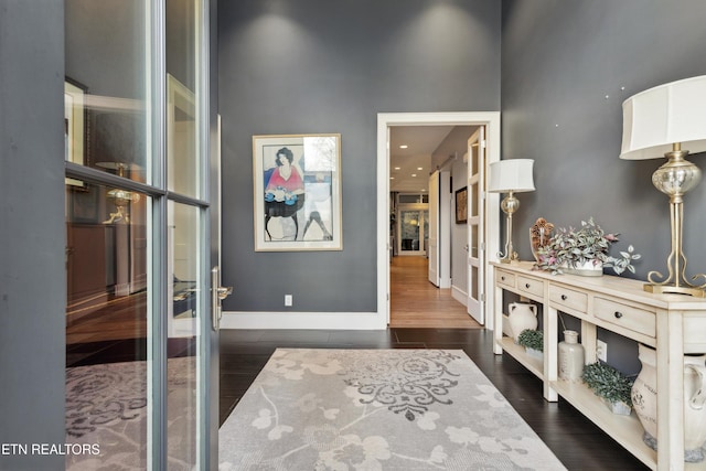 corridor featuring dark wood-style floors, french doors, and baseboards