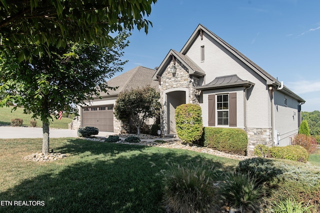 275 Hummingbird Dr, Vonore, TN 37885 - view of front of home featuring a front yard, a garage, stone siding, and concrete driveway
