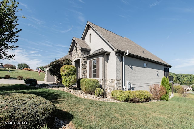 275 Hummingbird Dr, Vonore, TN 37885 - view of side of home with brick siding, stone siding, a yard, and roof with shingles