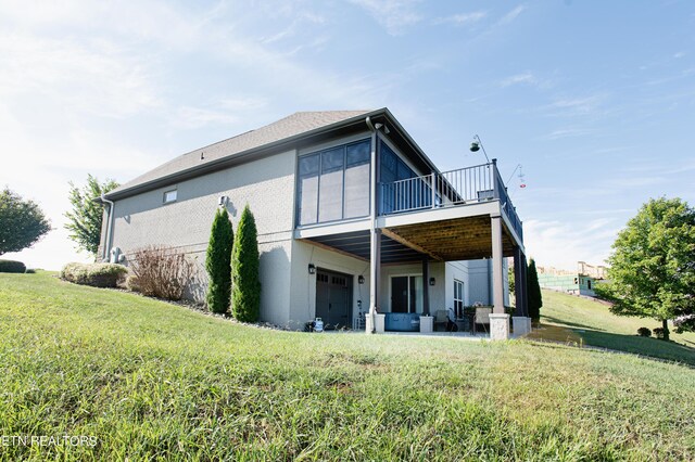 back of house featuring a yard and a patio