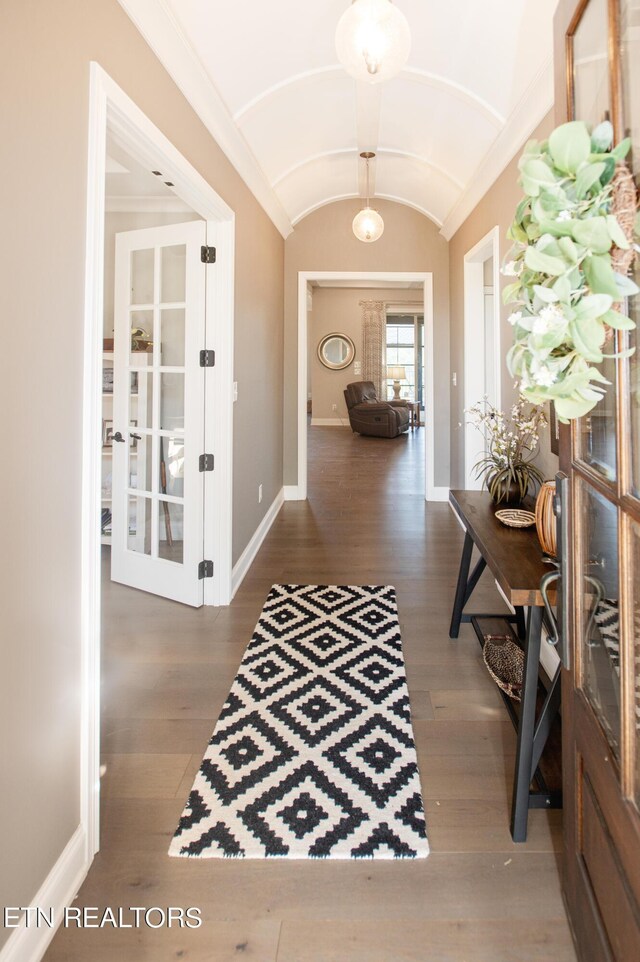 hall with french doors, lofted ceiling, and hardwood / wood-style flooring