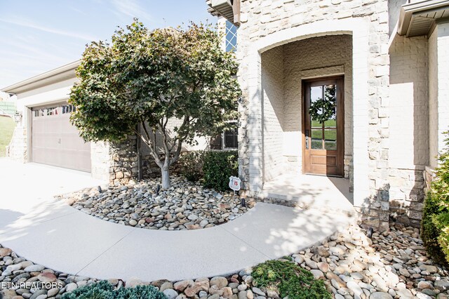 view of exterior entry featuring a garage