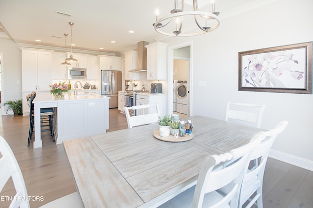 275 Hummingbird Dr, Vonore, TN 37885 - dining space featuring visible vents, washer / dryer, light wood-style floors, and an inviting chandelier