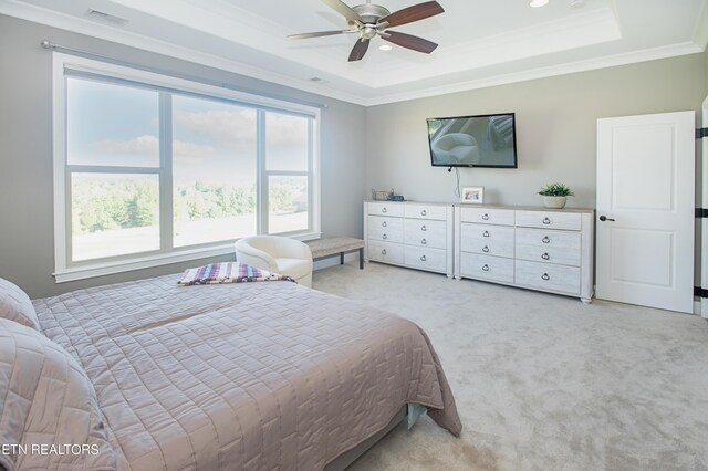 bedroom with crown molding, a raised ceiling, ceiling fan, and light colored carpet