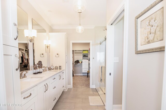 bathroom featuring tile patterned floors, walk in shower, crown molding, and vanity