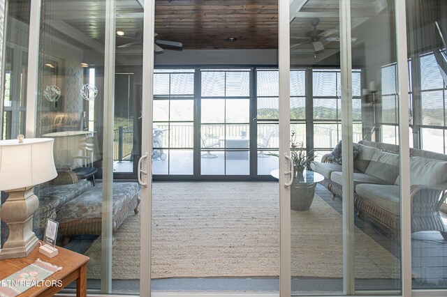 interior space with wood ceiling and ceiling fan