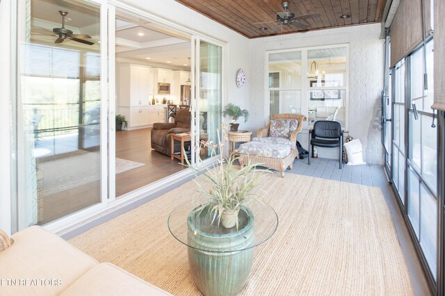 sunroom with a wealth of natural light, ceiling fan, and wood ceiling