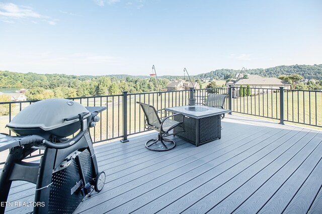 wooden terrace featuring a grill