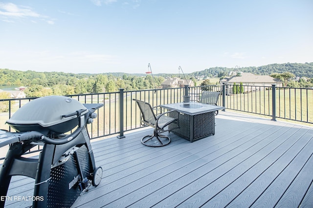 275 Hummingbird Dr, Vonore, TN 37885 - wooden deck with a grill and a view of trees
