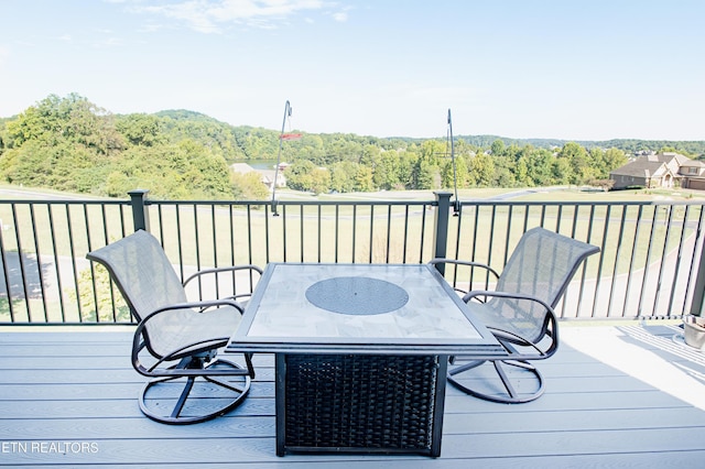 275 Hummingbird Dr, Vonore, TN 37885 - wooden terrace with outdoor dining area and a forest view