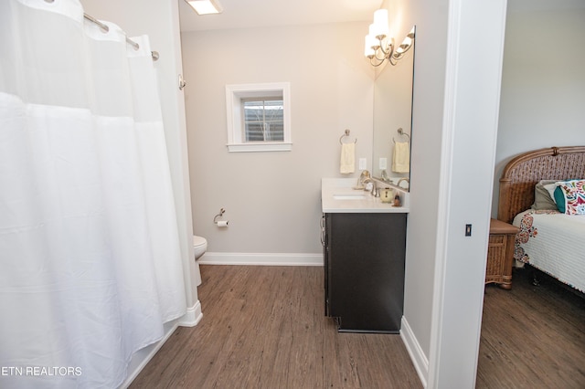 275 Hummingbird Dr, Vonore, TN 37885 - ensuite bathroom featuring connected bathroom, baseboards, toilet, wood finished floors, and vanity