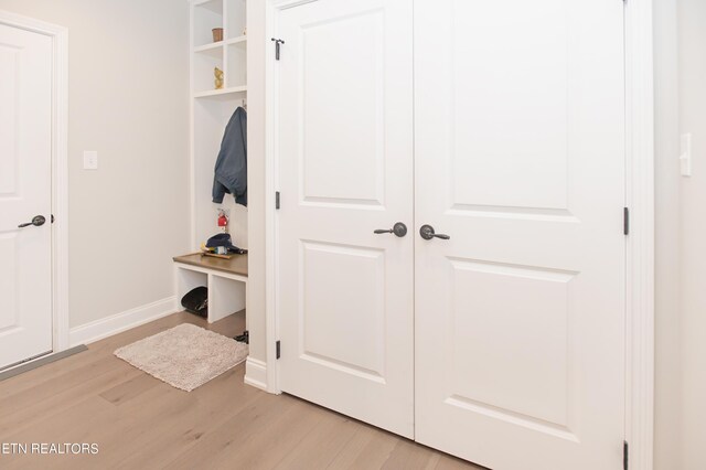 mudroom with light hardwood / wood-style floors