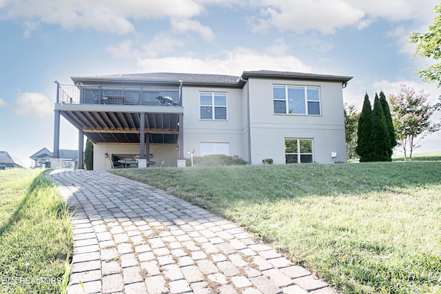 275 Hummingbird Dr, Vonore, TN 37885 - back of property featuring a balcony, stucco siding, and a yard