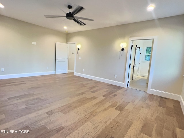 spare room with a ceiling fan, baseboards, light wood finished floors, and recessed lighting