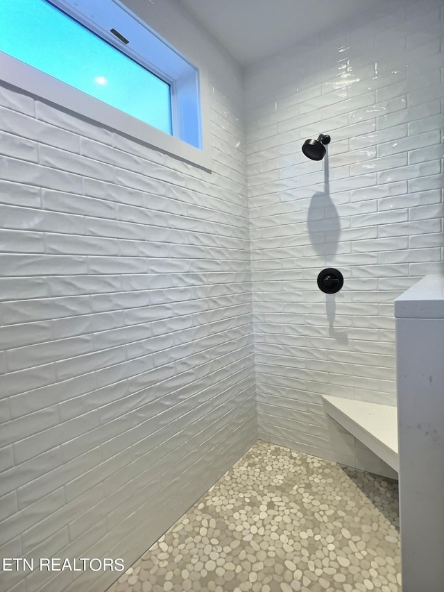 bathroom with a tile shower