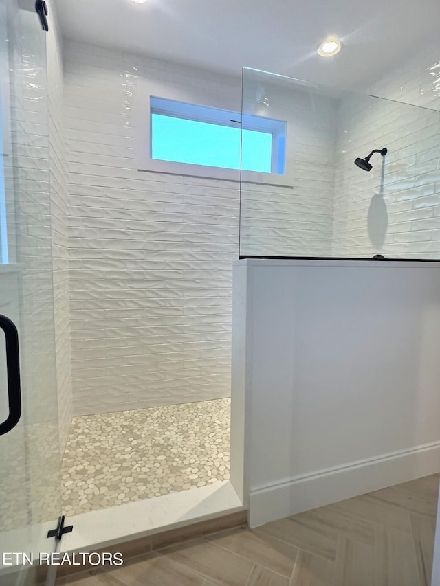 bathroom featuring baseboards and walk in shower