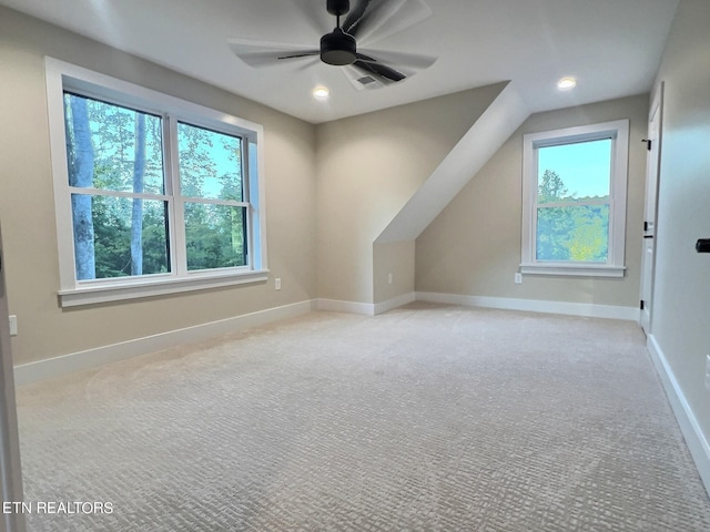 additional living space with baseboards, a wealth of natural light, recessed lighting, and light colored carpet