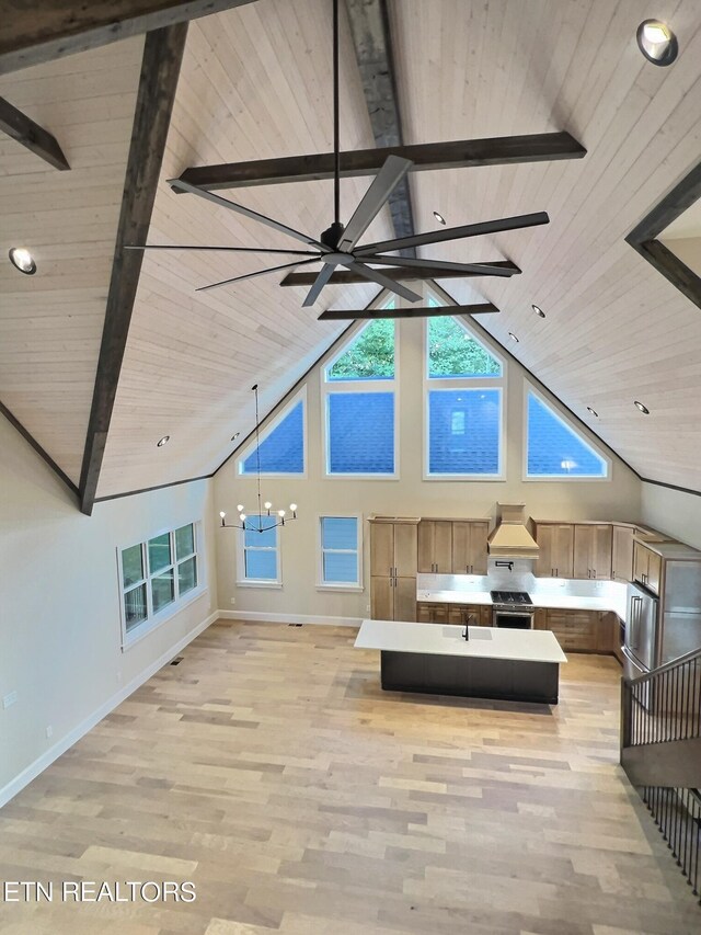 interior space with light wood-type flooring, high vaulted ceiling, an inviting chandelier, and wooden ceiling