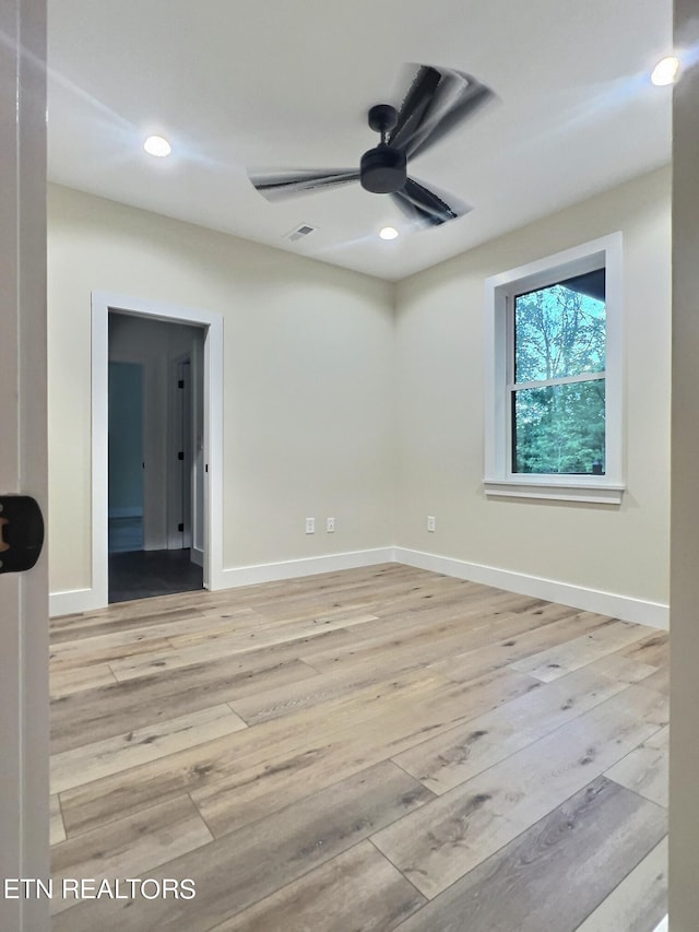 unfurnished room with a ceiling fan, light wood-style flooring, baseboards, and visible vents
