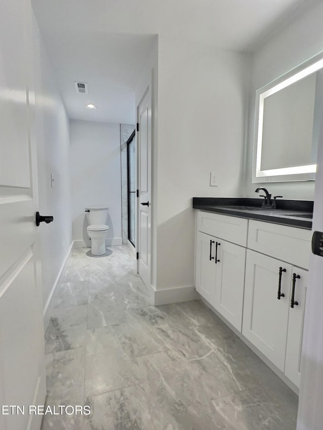 full bathroom featuring visible vents, marble finish floor, toilet, vanity, and a shower with door