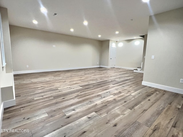 interior space featuring baseboards, recessed lighting, wood finished floors, and stairway