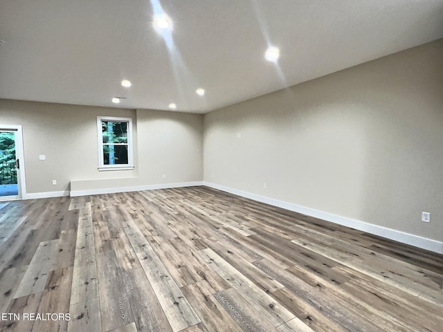 interior space featuring baseboards, wood finished floors, and recessed lighting