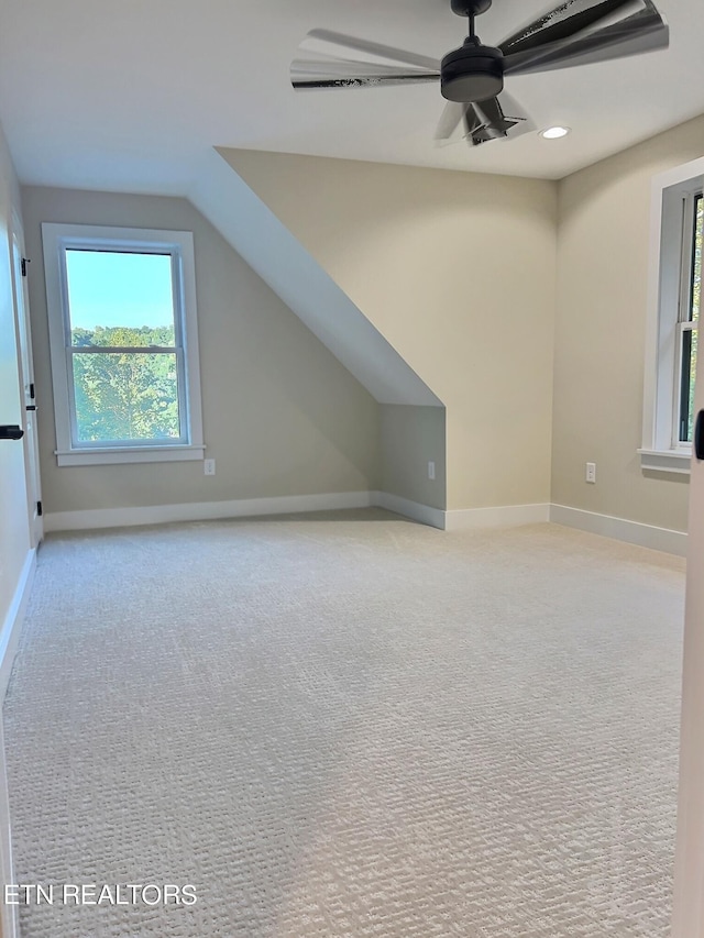 additional living space with carpet, a ceiling fan, lofted ceiling, baseboards, and recessed lighting