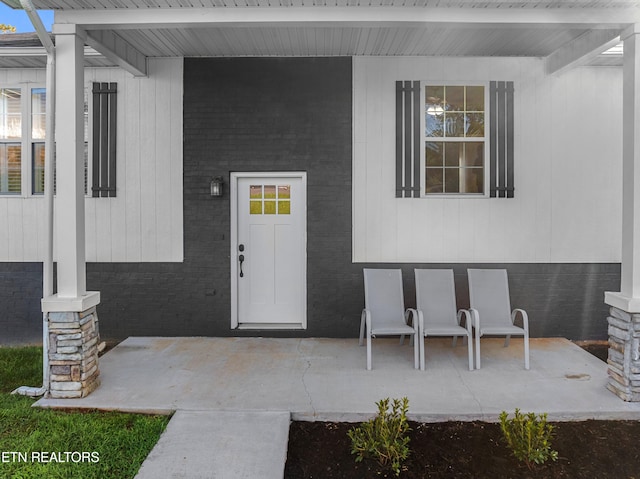 doorway to property featuring a porch