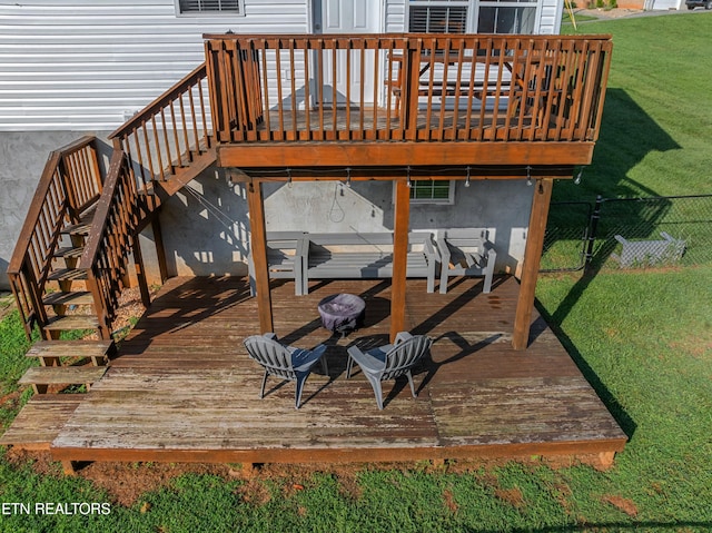 wooden terrace featuring a yard