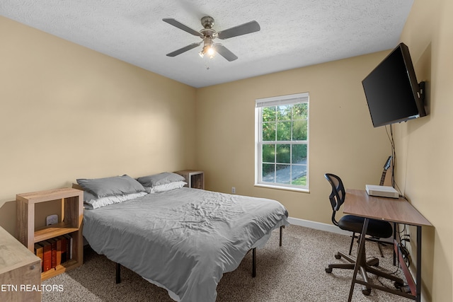 bedroom featuring ceiling fan, a textured ceiling, and carpet floors