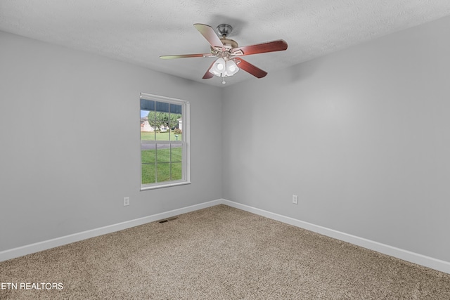 carpeted empty room with a textured ceiling and ceiling fan